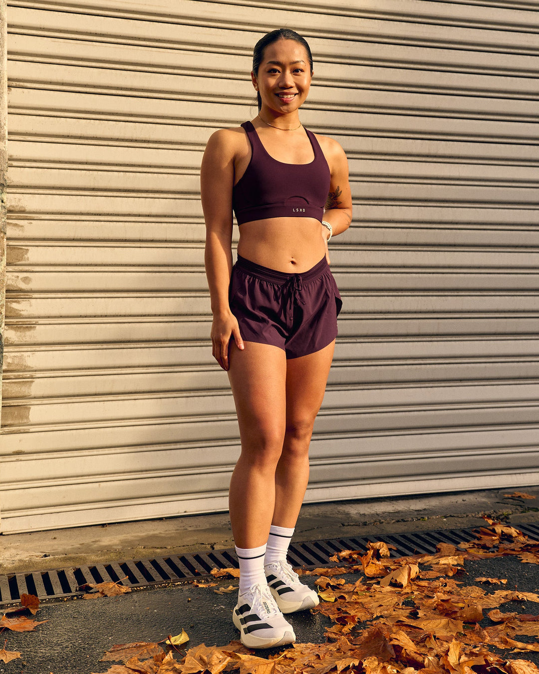 Woman wearing Accelerate 3" Mid-Rise Running Short - Cherry Lacquer