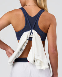 Woman wearing Unstoppable Racerback Sports Bra - Future Navy| Model:Issy| Size:XS | Thumbnail Index: 1