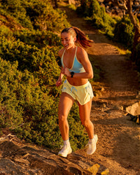 Woman wearing GG Accelerate 3" Mid-Rise Running Short - Baltic Sea-Lemon | Model:Grace | Size:S