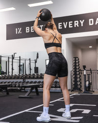 Woman wearing Fusion Ultra High-Rise 6" Short Pockets - Black Camo | Model:Abbey | Size:S