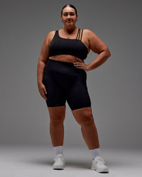 Woman wearing Fusion Ultra High-Rise 9" Short Pockets - Black | Model:Jordie | Size:2XL