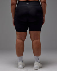 Woman wearing Fusion Ultra High-Rise 9" Short Pockets - Black | Model:Jordie | Size:2XL