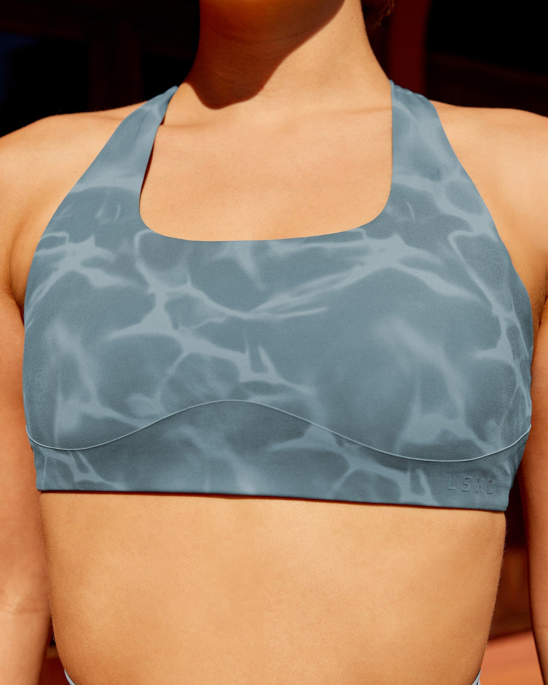 Woman wearing Aspire Sports Bra - Tranquil-Elemental Blue