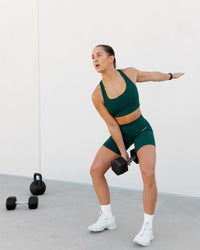 Woman wearing Base 2.0 Ultra High-Rise 6" Short - Dark Moss