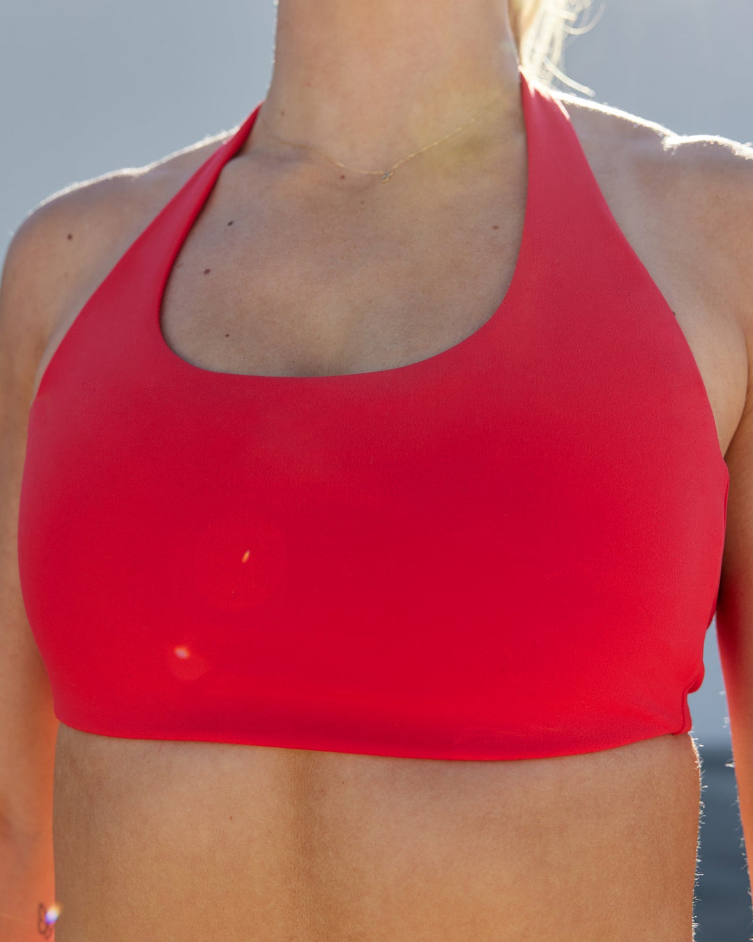 Woman wearing Challenger Sports Bra - Scarlet