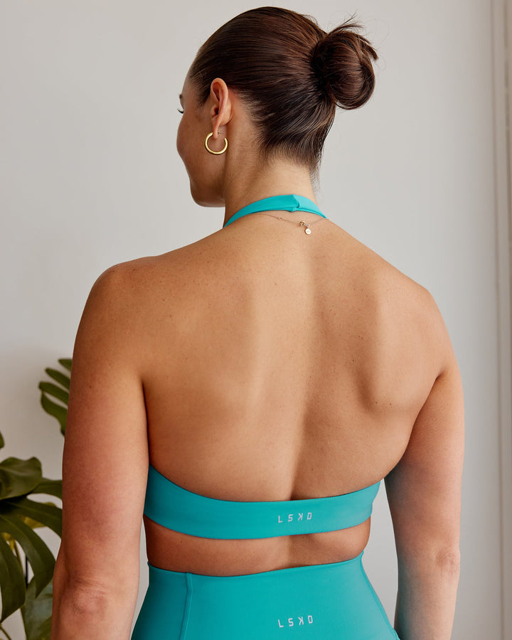 Woman wearing Challenger Sports Bra - Uplift Blue
