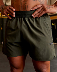 Man wearing Competition 5" Performance Short - Forest Night