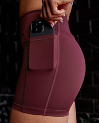 Woman wearing Elite High-Rise 4" Short Pockets - Dark Cherry
