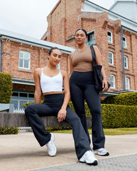 Woman wearing Fusion Ultra High-Rise Flared Legging - Black | Model:Milly | Size:S