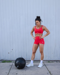 Woman wearing Flux Ultra High-Rise 4" Short Pockets - Scarlet