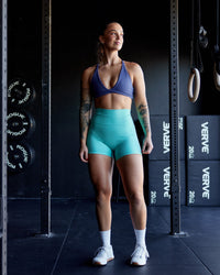 Woman wearing Fusion Ultra High-Rise 4" Short Pockets - Aquatic Awe | Model:Robyn | Size:S
