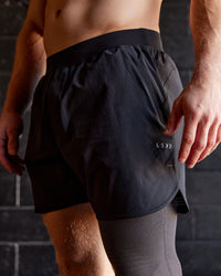 Man wearing Lift 6" Performance Shorts - Black-Reflective