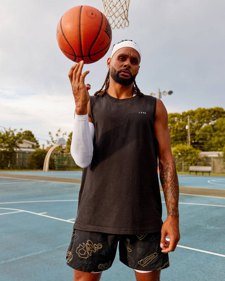 Man wearing Patty Mills Perform VapourFLX Muscle Tank - Black Reflective
