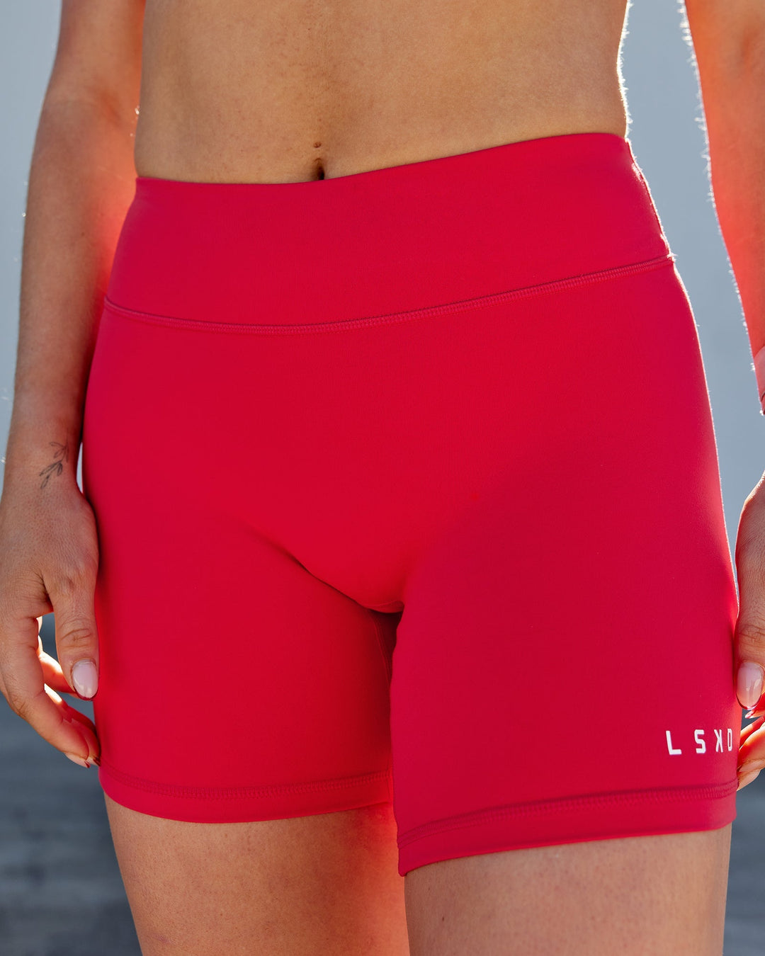 Woman wearing RXD Mid-Length Shorts - Scarlet