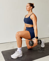Woman wearing Twist Sports Bra - Future Navy | Model:Abbey | Size:S