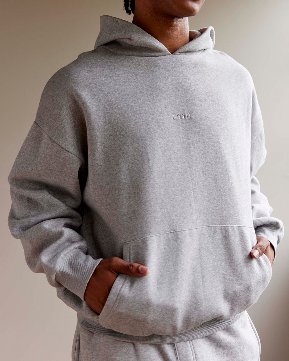 Man wearing Unisex MVP Hoodie Oversize - Lt Grey Marl