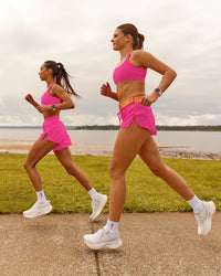 Woman wearing Velocity Sports Bra - Ultra Pink | Model:Duo | Size:Both