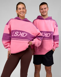 Duo wearing A-Team Oversized Hoodie - Candy Pink-Boysenberry | Model:Amity | Size:S | Model:Arran | Size:M