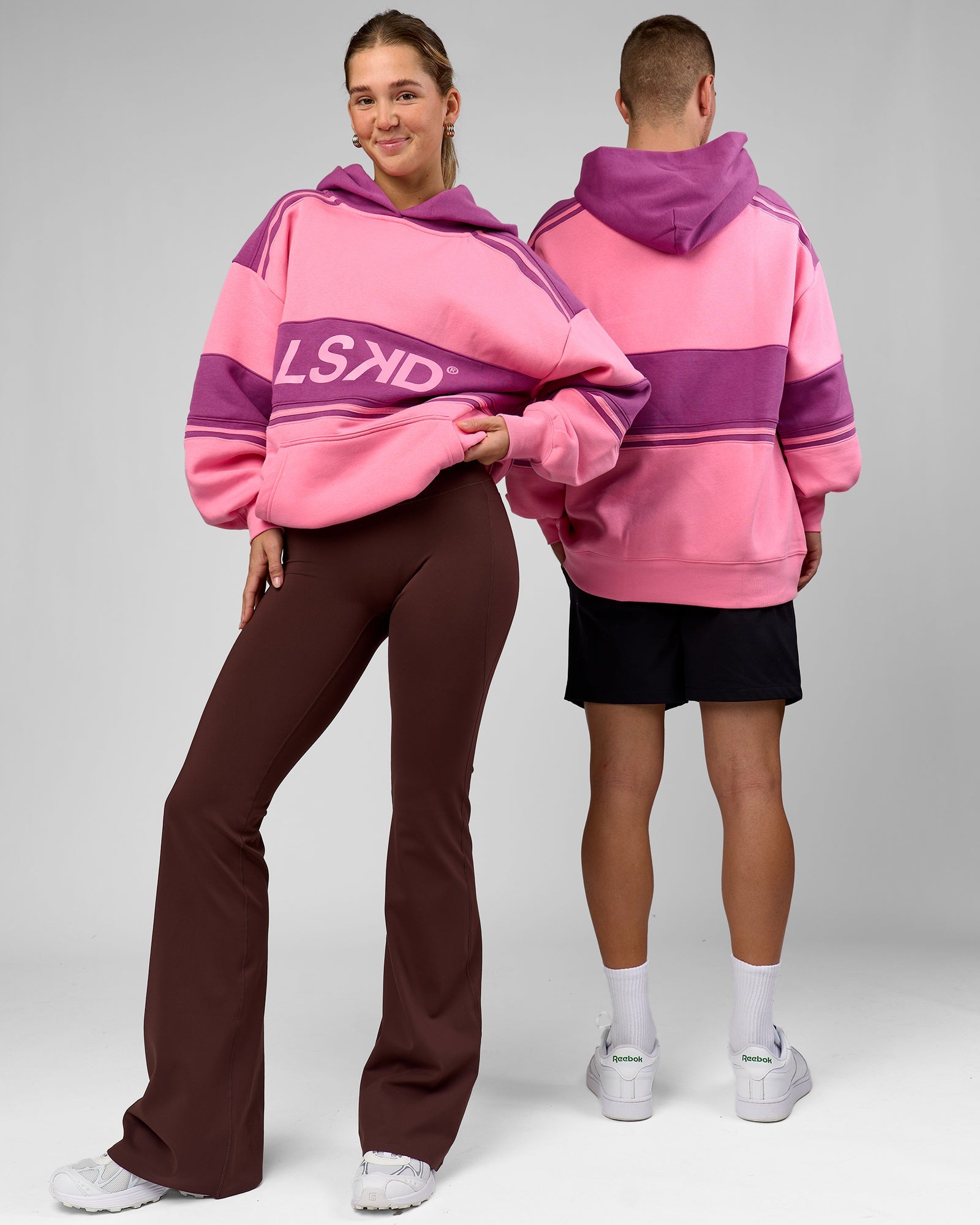 Duo wearing A-Team Oversized Hoodie - Candy Pink-Boysenberry | Model:Amity | Size:S | Model:Arran | Size:M