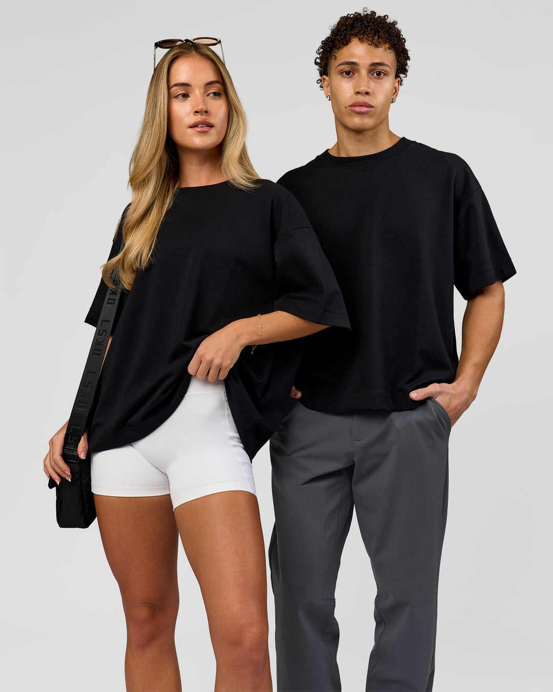 Duo wearing AfterDark ZeroCrease Boxy Tee in Black | Model:Issy | Size:XS | Model:Leandro | Size:M