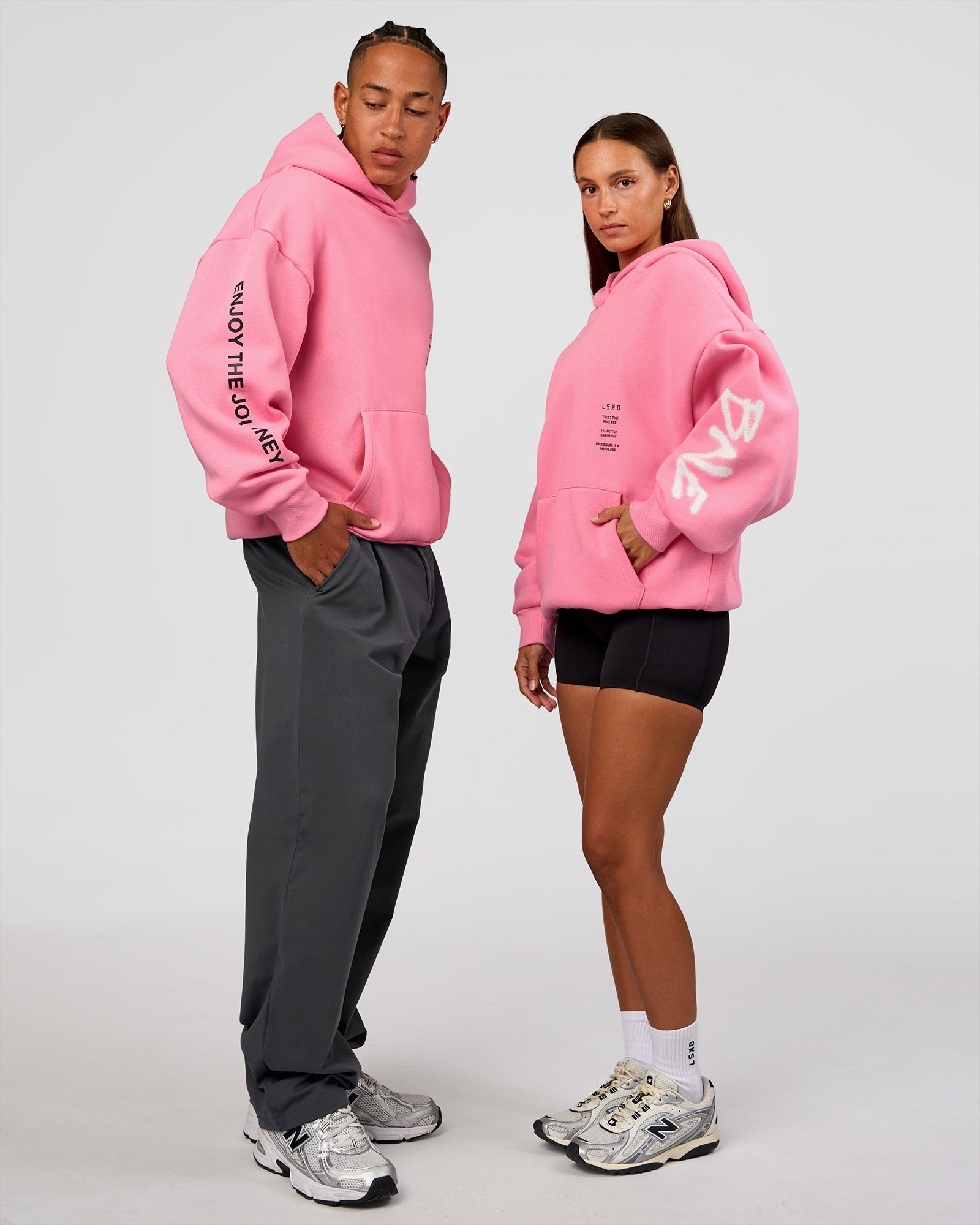 Duo wearing CFT BNE 26 Unisex Oversized Hoodie - Candy Pink-Black | Model:Brylee | Size:XS | Model:Malebo | Size:M