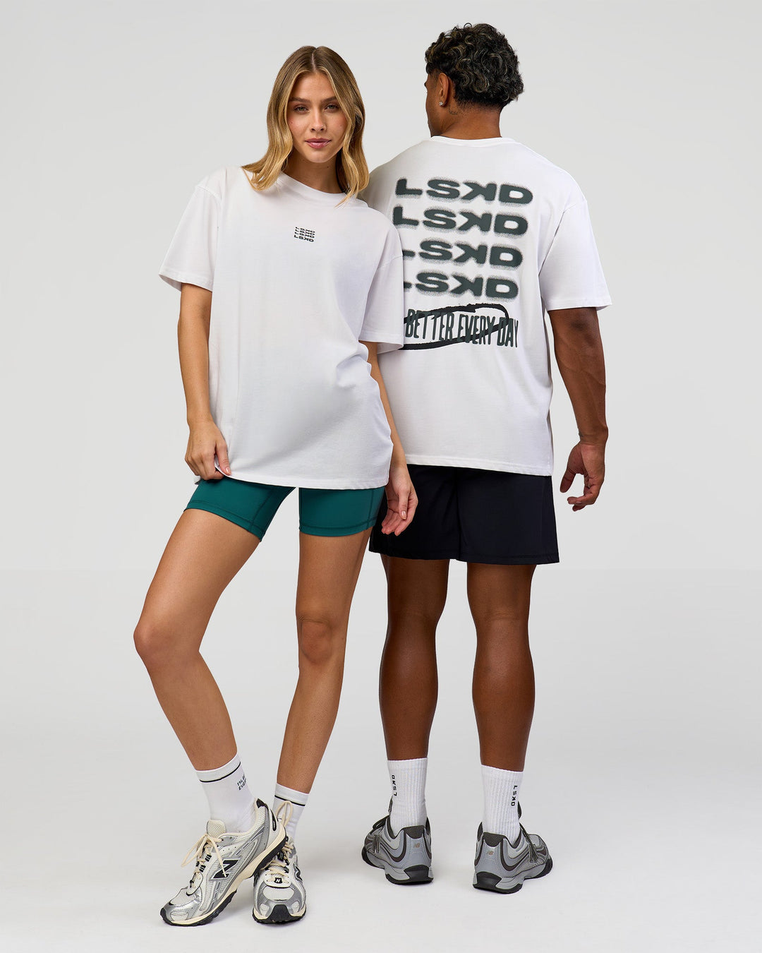 Duo wearing Everyday Elevation FLXCotton Oversized Tee - White-Carbon Green | Model:Leilani | Size:XS | Model:Xav | Size:L
