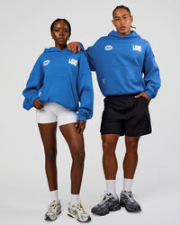 Duo wearing Static Grit Unisex Boxy Hoodie - Palace Blue-White | Model:Both | Size:Duo
