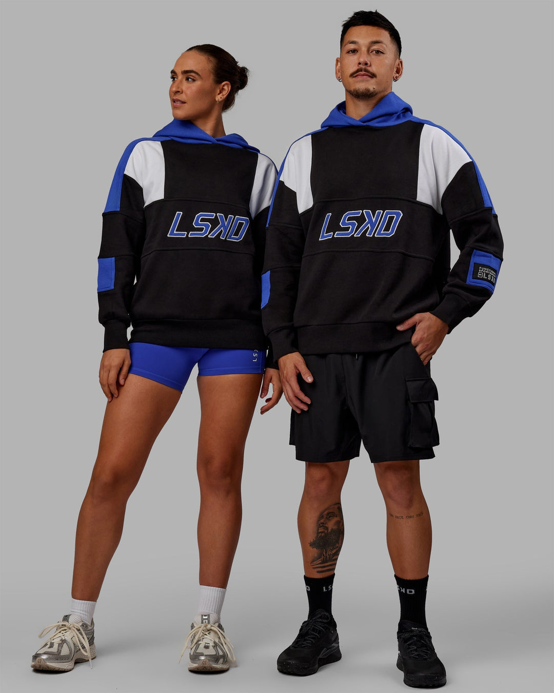 Duo wearing Unisex Slam Hoodie Oversize - Black-Power Cobalt