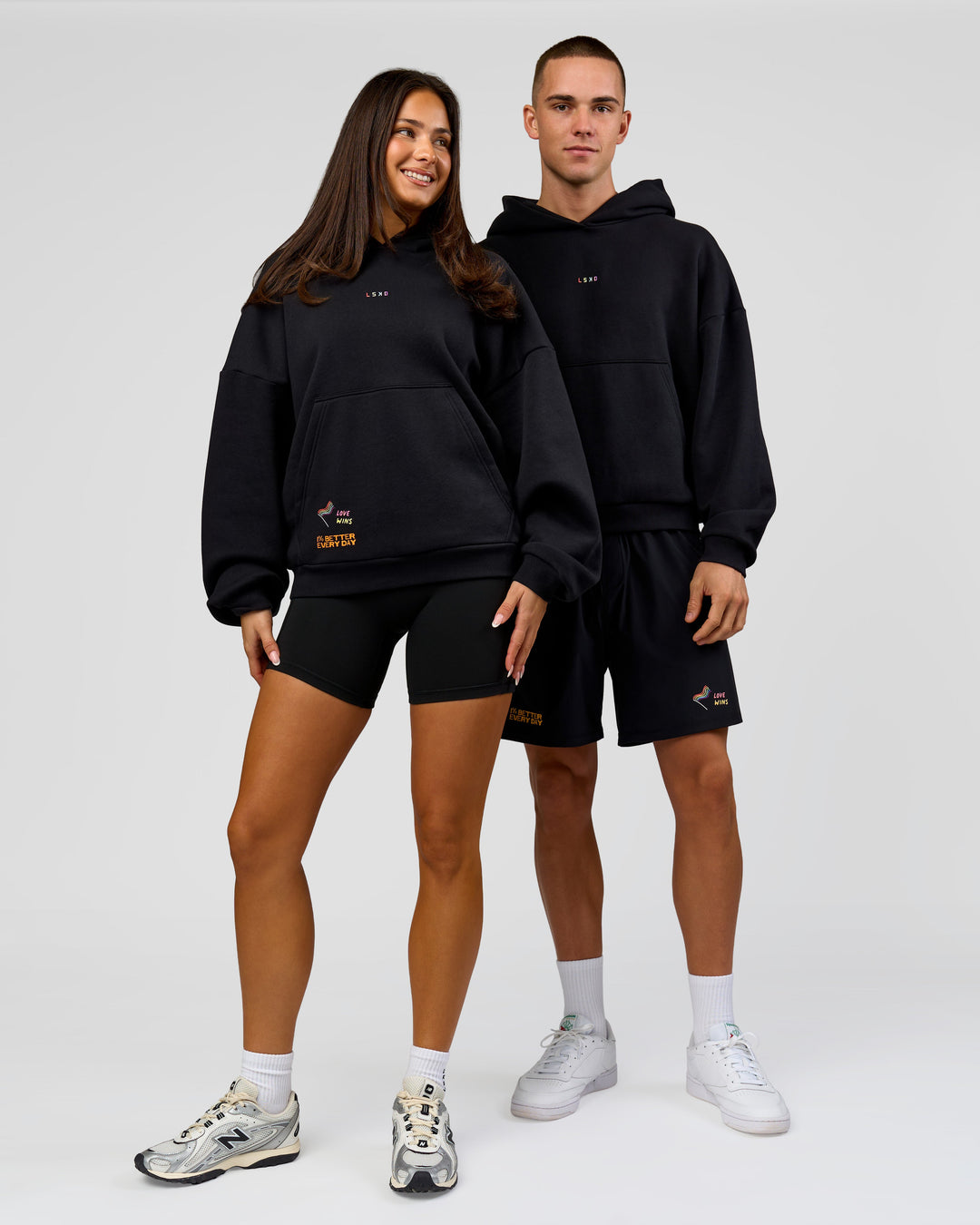 Duo wearing Pride Sticker Boxy Hoodie - Black | Model:Bianca | Size:XS | Model:Albert | Size:M
