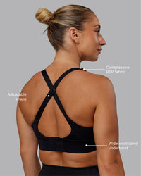 Woman wearing Accelerate Sports Bra in Black | Model:Lyss | Size:S