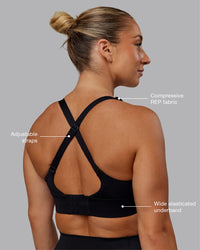 Woman wearing Accelerate Sports Bra in Black | Size:S
