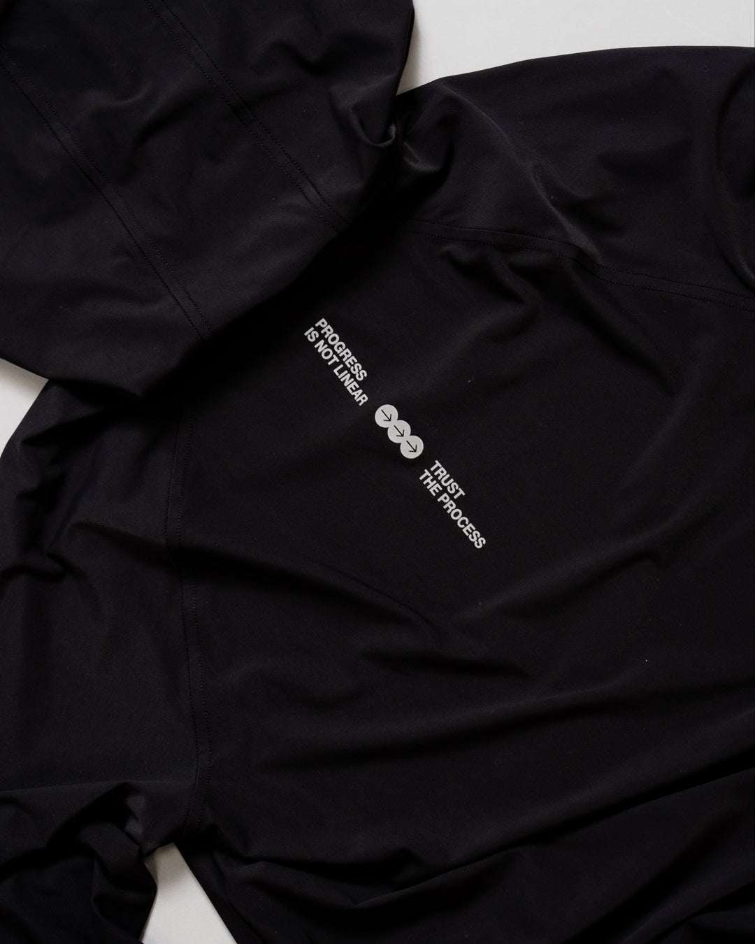 Flatlay of On the Run Long Sleeve in Black back panel with reflective details