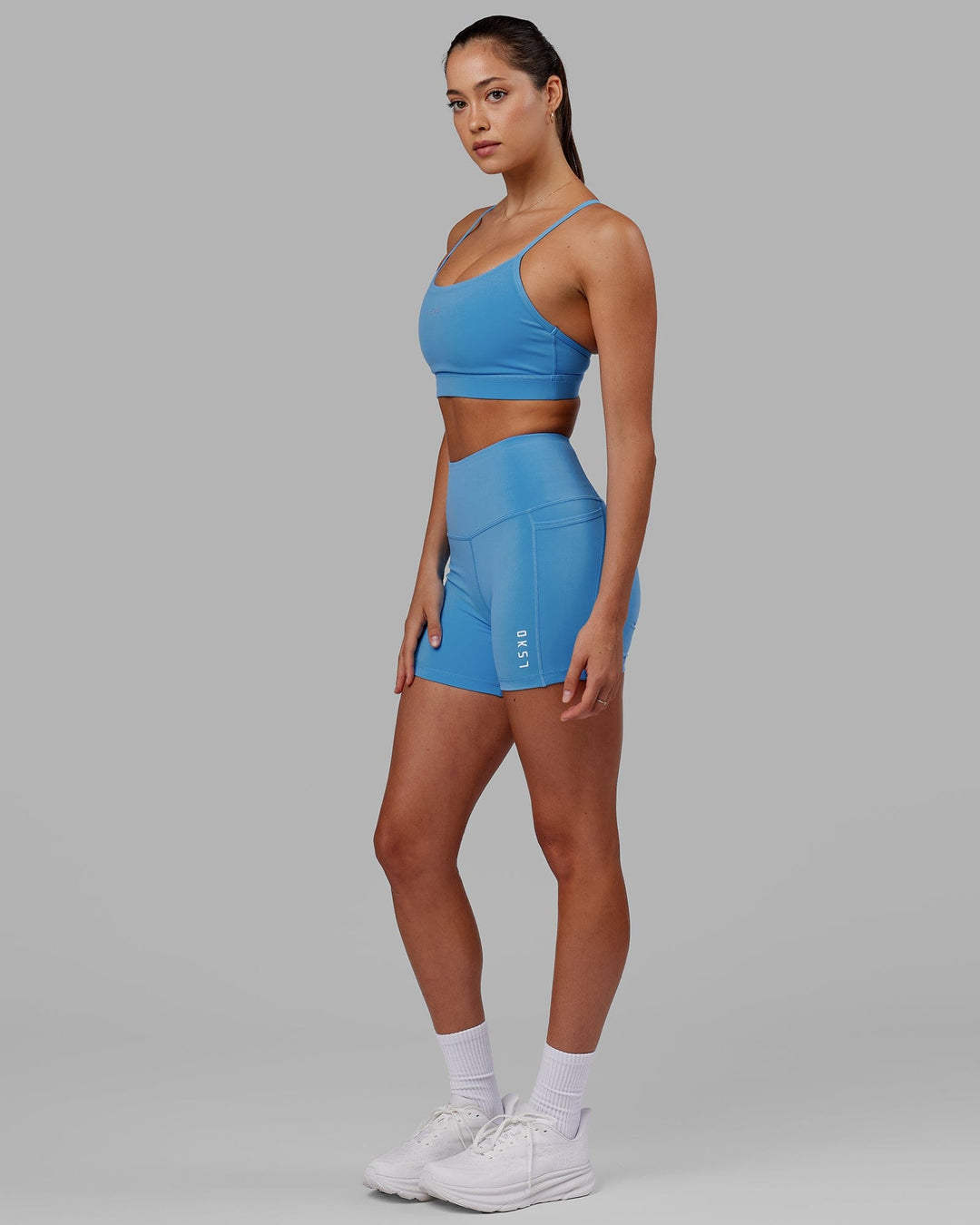 Woman wearing Flux Ultra High-Rise 4" Short Pockets - Azure Blue