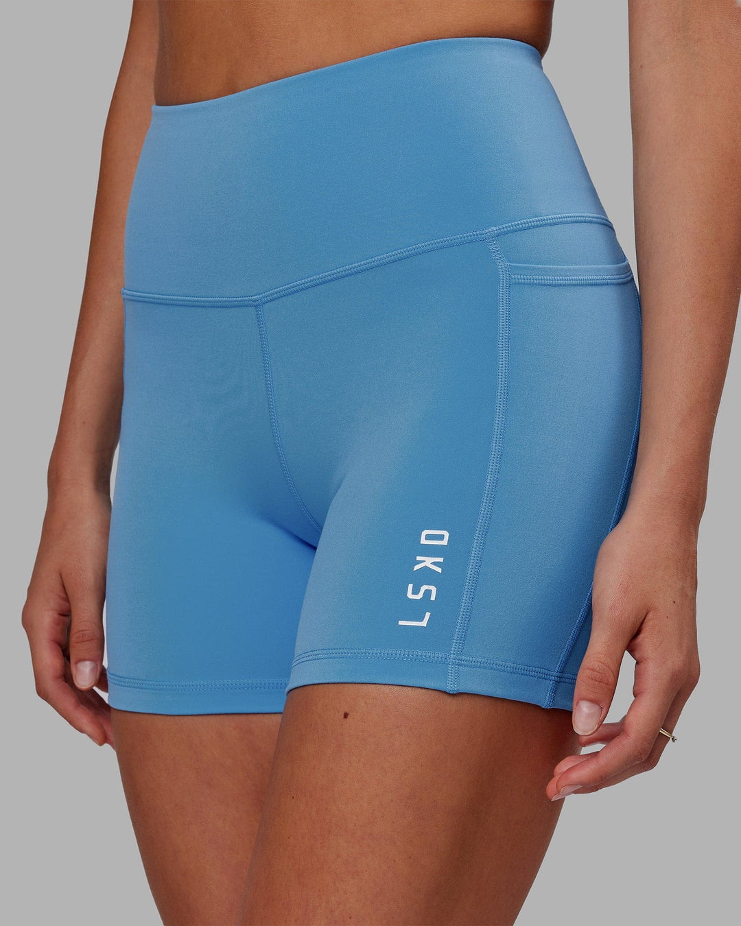 Woman wearing Flux Ultra High-Rise 4" Short Pockets - Azure Blue