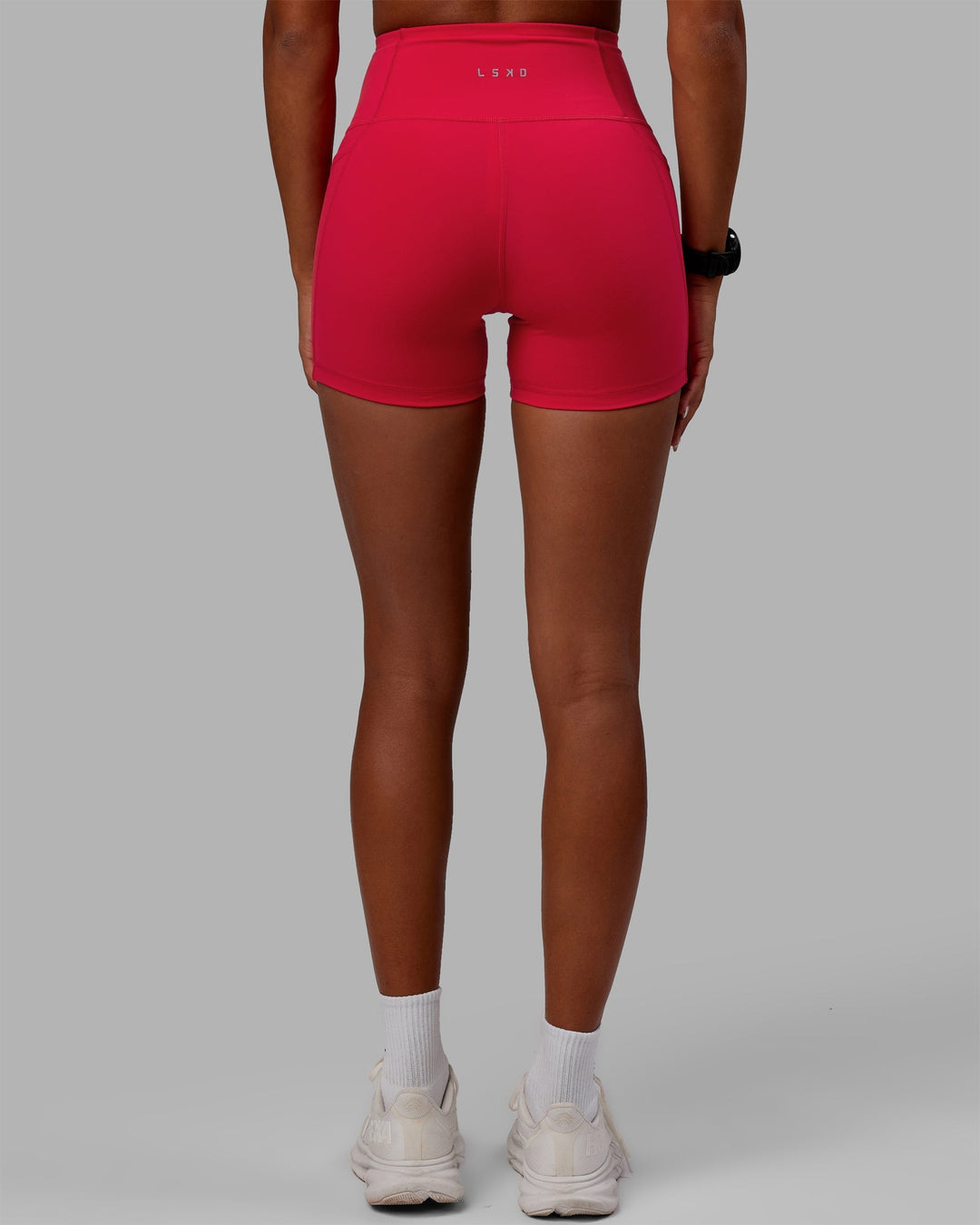 Woman wearing Flux Ultra High-Rise 4" Short Pockets - Scarlet