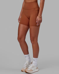Woman wearing Fusion Ultra High-Rise 6" Short Pockets - Hazel | Set:true | Angle:side | Model:Milly | Size:S