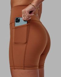 Woman wearing Fusion Ultra High-Rise 6" Short Pockets - Hazel | Set:true | Angle:closeup | Model:Milly | Size:S