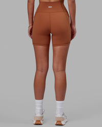 Woman wearing Fusion Ultra High-Rise 6" Short Pockets - Hazel | Set:true | Angle:back | Model:Milly | Size:S