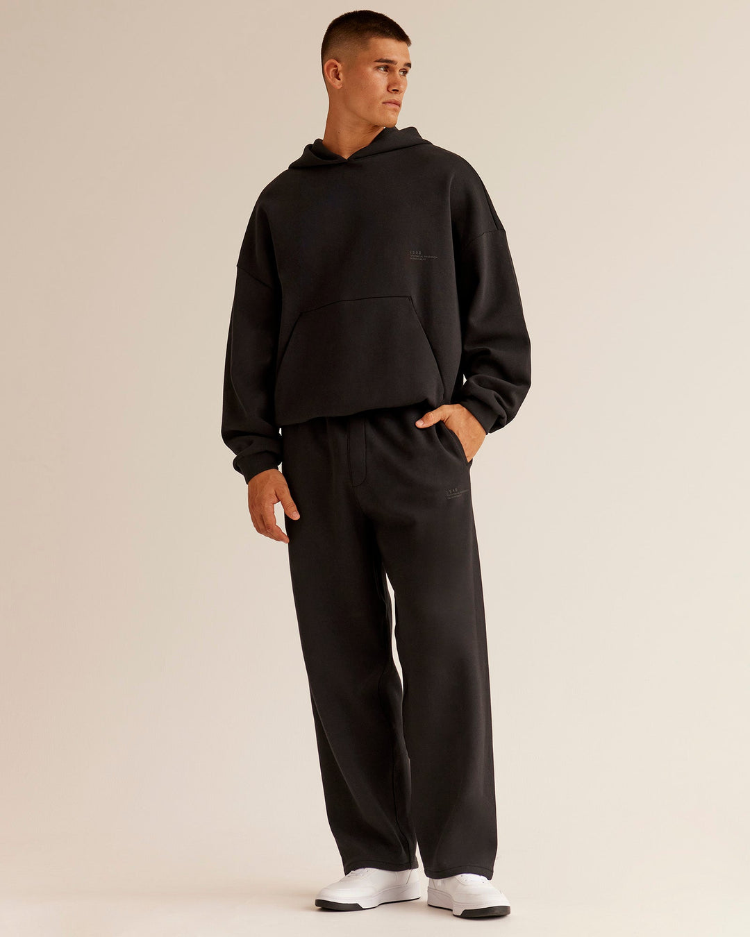 Man wearing AfterDark ZeroCrease Straight Leg Pant - Black | Model:Jackson | Size:L