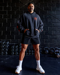 Man wearing Journey Washed Unisex Oversize Hoodie - Black-Ultra Orange | Model:Hiko | Size:L