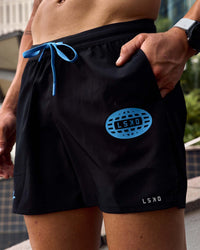 Man wearing Pace 5" Lined Running Short - Black-Palace Blue | Model:Cooper | Size:L