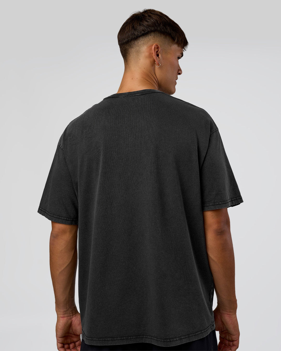 Man wearing 1% Better Every Day EST FLXCotton Oversized Tee - Black Washed | Model:Jackson | Size:L