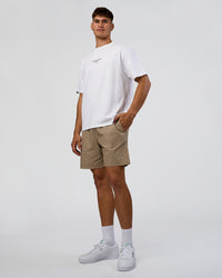 Man wearing 1% Better Every Day EST FLXCotton Oversized Tee - White | Model:Jackson | Size:L