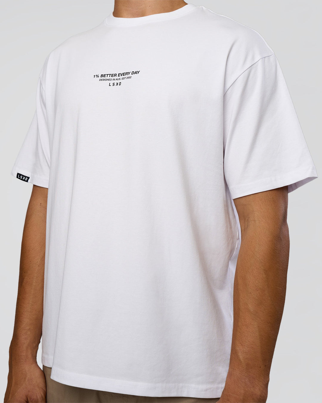 Man wearing 1% Better Every Day EST FLXCotton Oversized Tee - White | Model:Jackson | Size:L