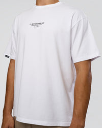 Man wearing 1% Better Every Day EST FLXCotton Oversized Tee - White | Model:Jackson | Size:L