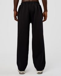 Man wearing AfterDark ZeroCrease Straight Leg Pant - Black | Model:Okello | Size:L