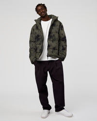 Man wearing Base Puffer Jacket - Camo Washed Walnut Grey | Model:Okello | Size:L