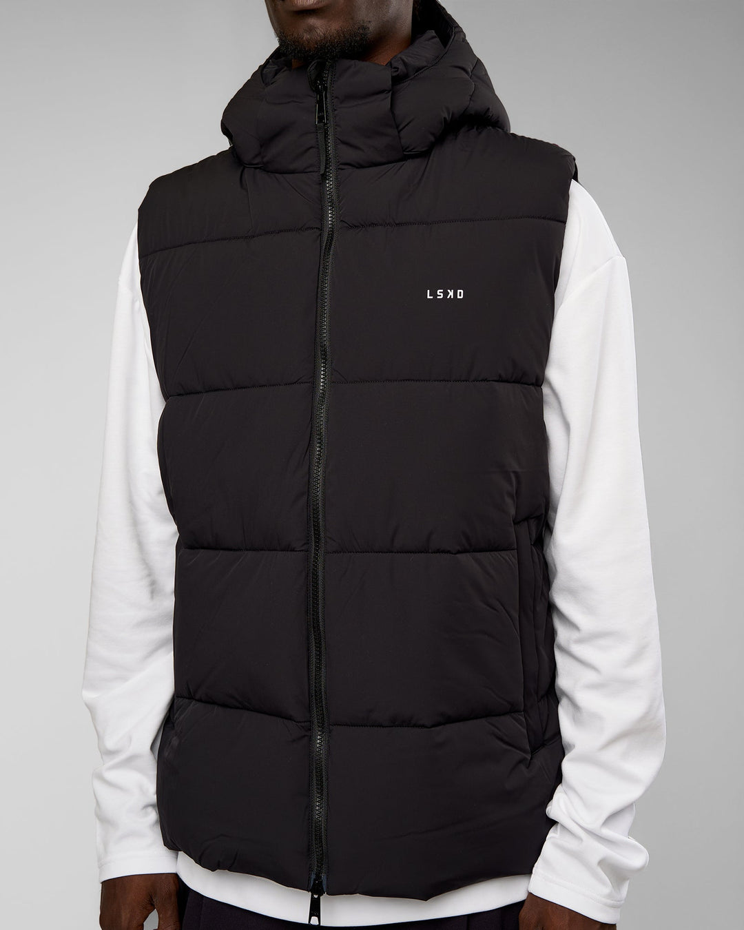 Man wearing Base Puffer Vest - Black | Model:Okello | Size:L