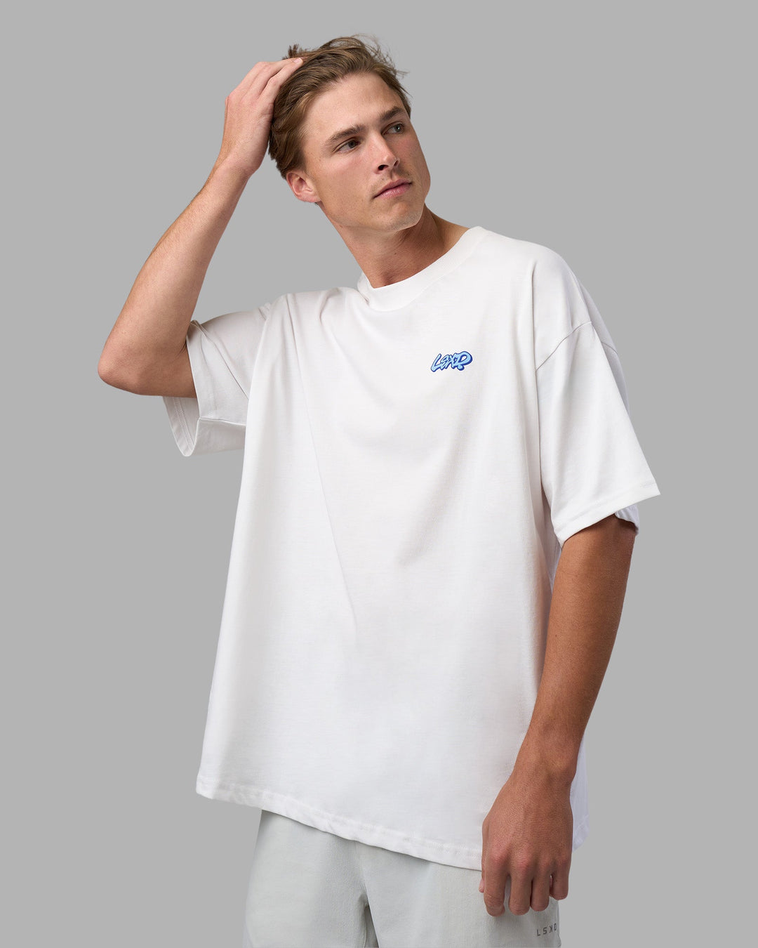 Man wearing Break Through Heavyweight Oversized Tee - White-Power Cobalt | Model:Brandon | Size:L