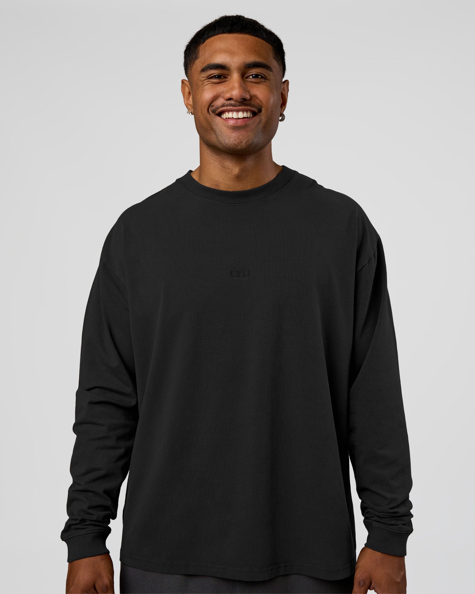 Man wearing Classic Heavyweight FLXCotton Oversized Long Sleeve Tee - Washed Black-Black | Model:Xav | Size:L